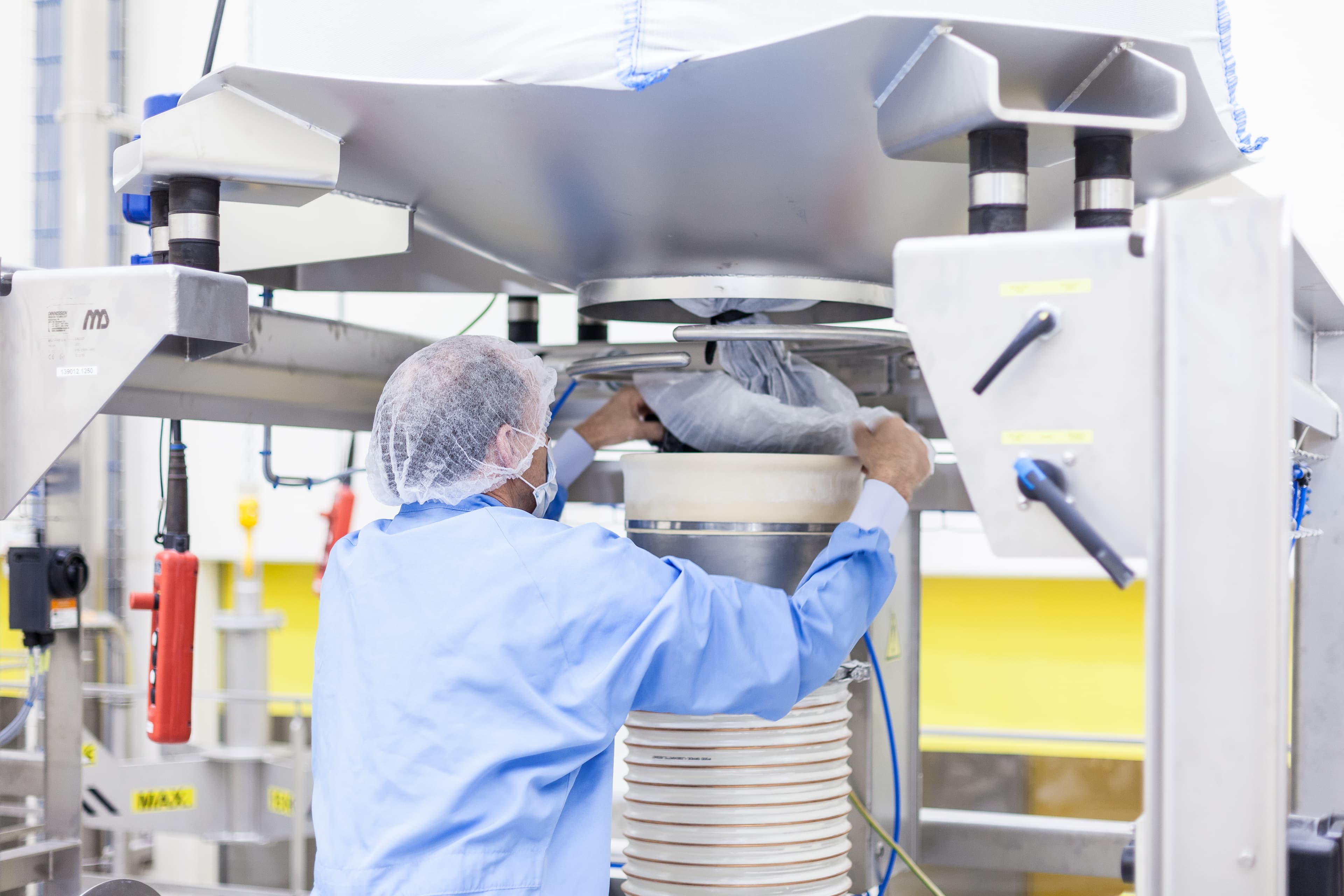Employee operating the Buisman powder packaging line
