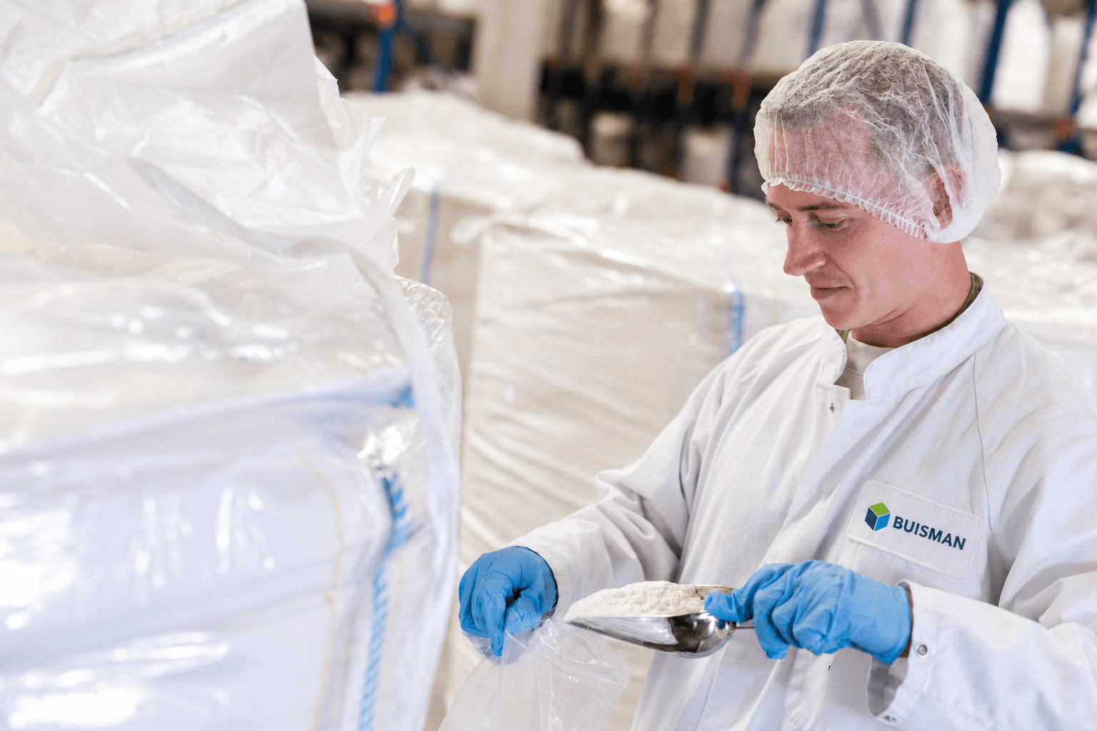 Employee checking powder quality in production